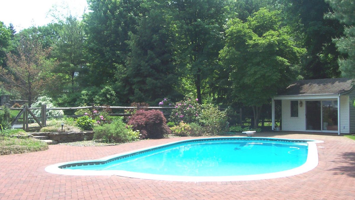 backyard pool and patio with garden and shed, spring project