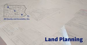 land planning header image with planning documents laid on a table in the background