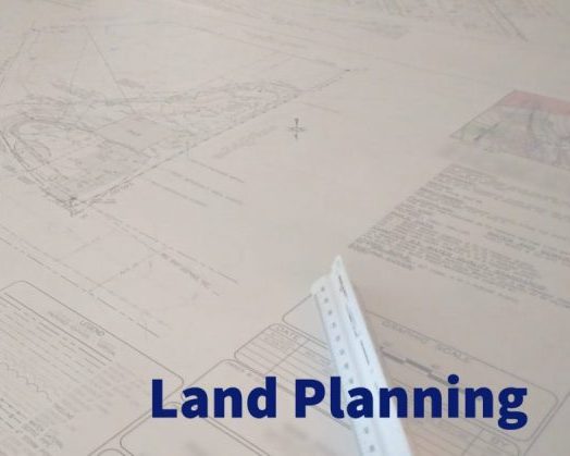 land planning header image with planning documents laid on a table in the background