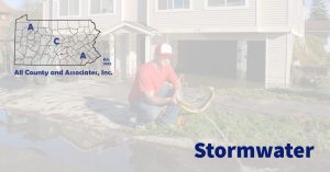 stormwater header image with a person holding a drainage hose helping drain a flooded property