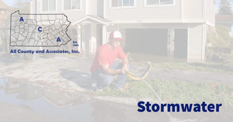 stormwater header image with a person holding a drainage hose helping drain a flooded property